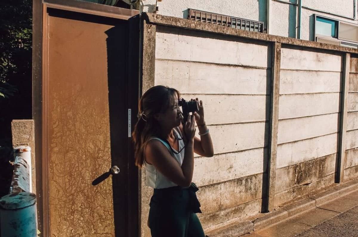 woman holding a camera and taking a shot