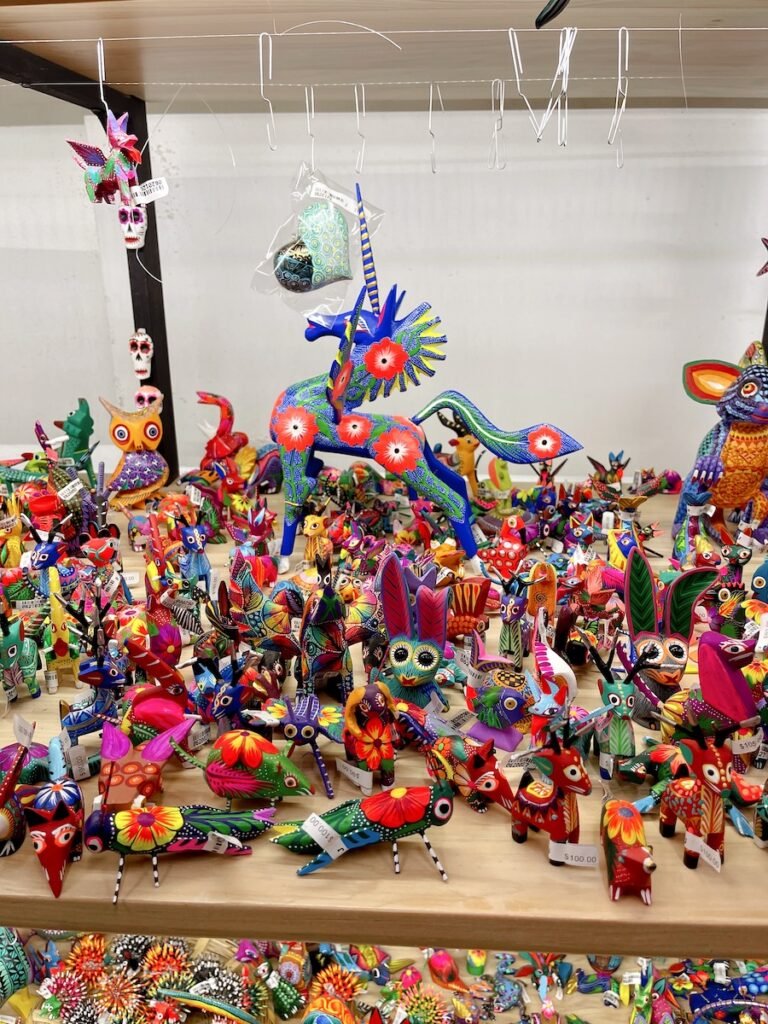 collection of colorful alebrijes - mexican wood figures featuring various animals