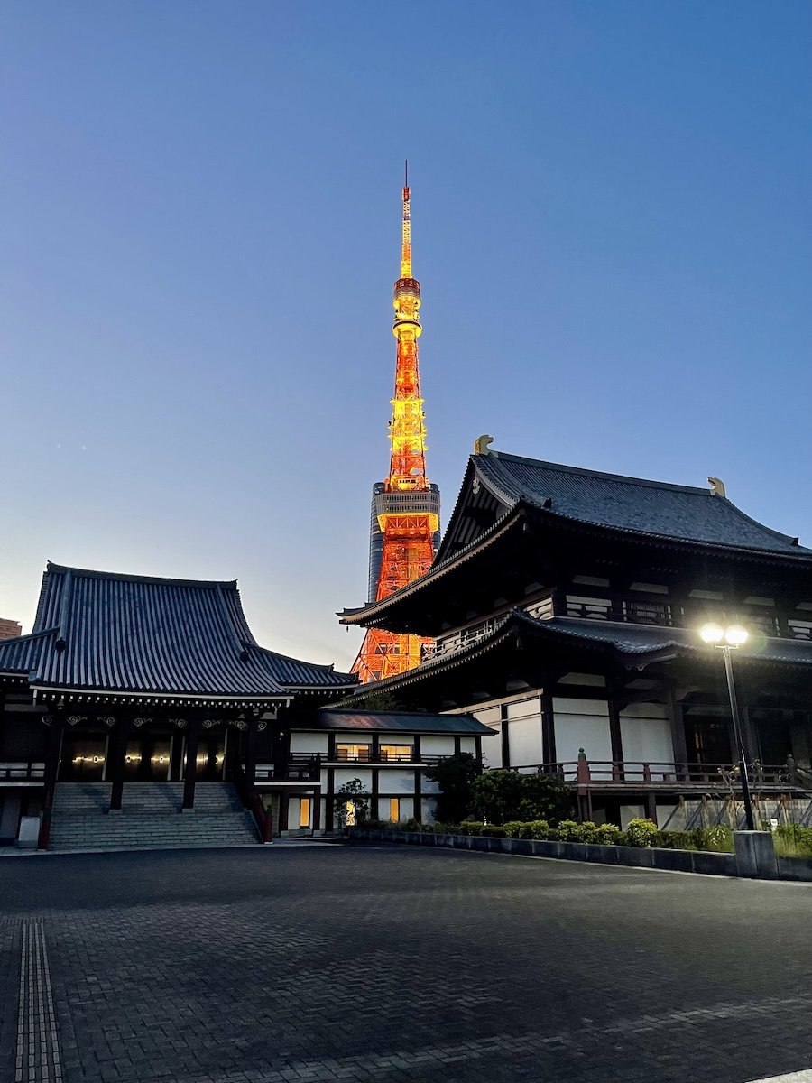 image of tokyo tower at dusk with traditional temples in the foreground