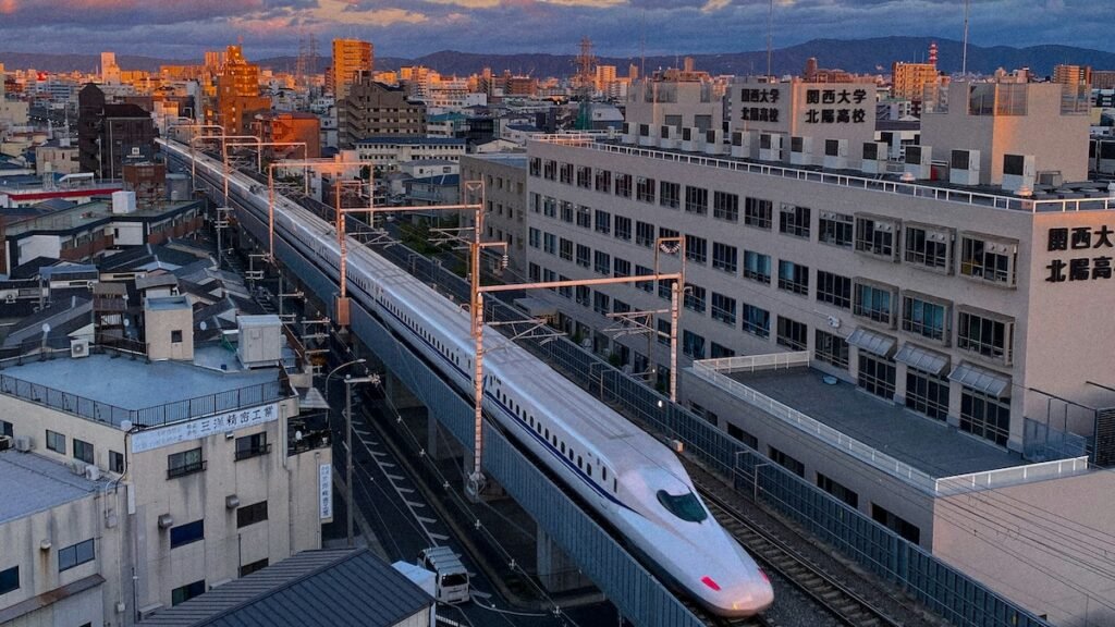 aerial image of the bullet train in japan, known as the shinkansen, with surrounding buildings