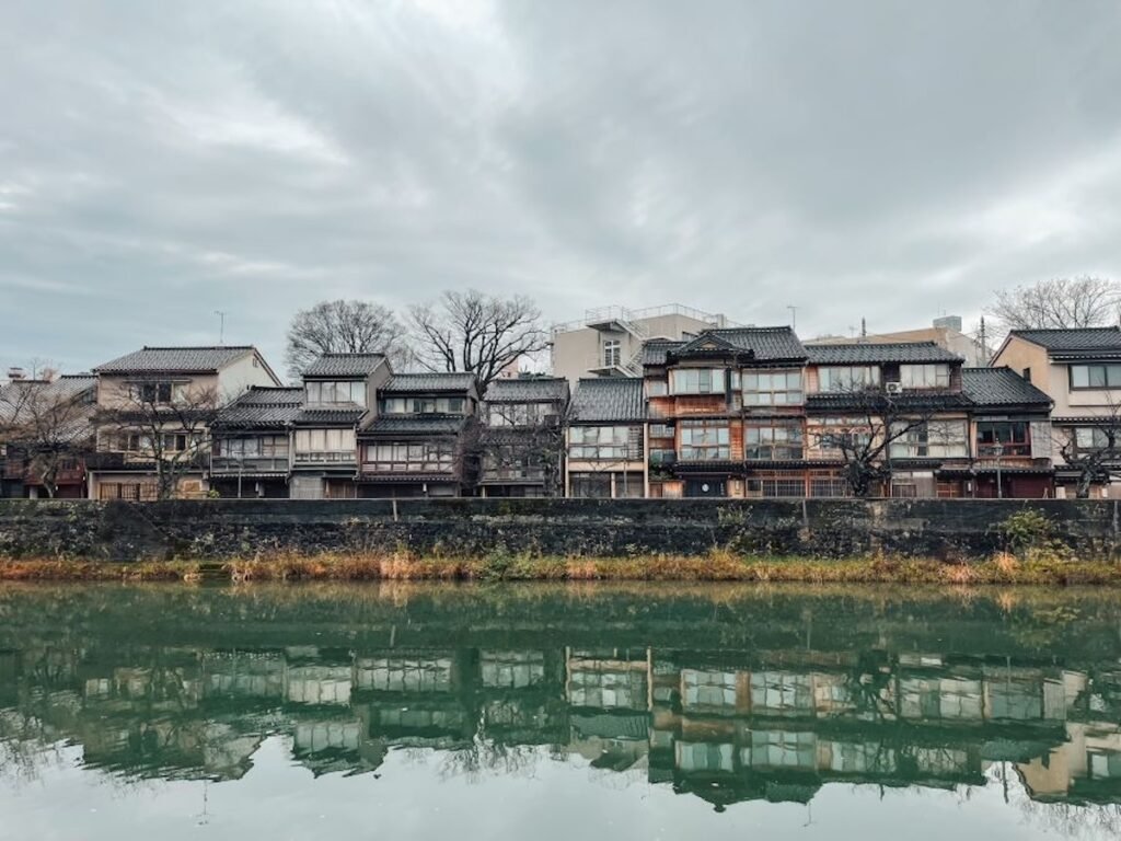 image from across a river of kanazawa houses along the river