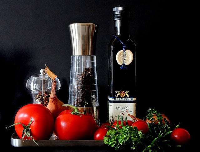 Bottle of truffle oil with a few truffle shavings next to it