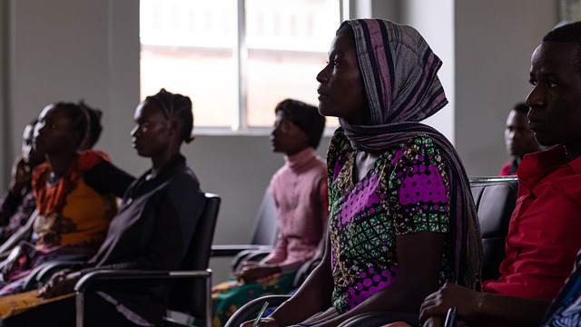 A classroom with a multicultural group of students actively participating and interacting positively
