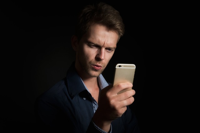 Person using a smartphone to make a call in a rural setting